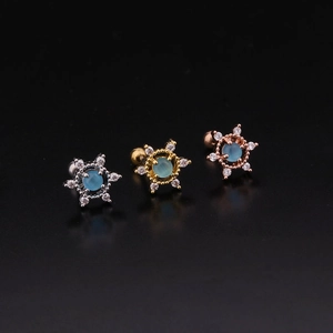 Detailed macro view of opal screw back stud earrings in silver, gold, and rose gold