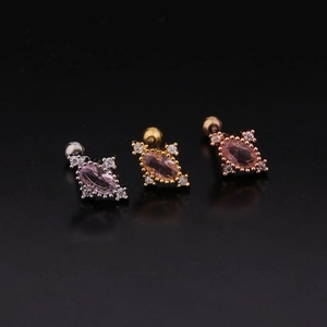 Macro shot of silver, gold, and rose gold screw-back stud earrings with round zircons
