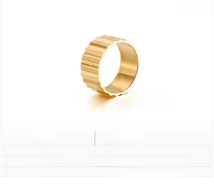 Detail view of 9mm wide gear-patterned stainless steel ring with polished golden finish
