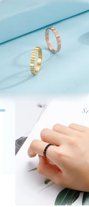 Detail showing wavy gear-shaped titanium steel rings in gold, rose gold and black colors