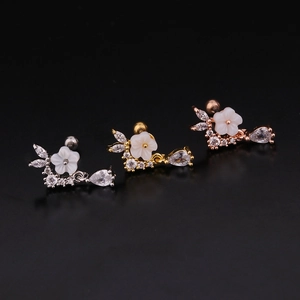 Zircon flower stud earrings in silver, gold, and rose gold finishes on black background