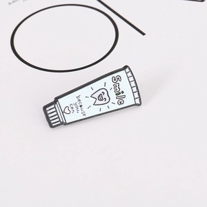 Cartoon toothpaste enamel pin with Smile because you can slogan on white background