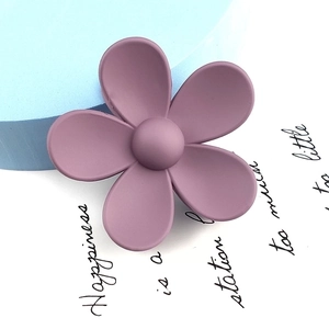 Macro shot of large matte purple flower hair claw clip with elegant five-petal design