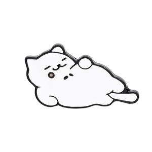 Detail shot of a cute white sleeping cat enamel pin with polished black outlines