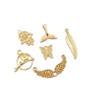 Assorted gold alloy charms including hand, wing and whale tail for DIY jewelry making