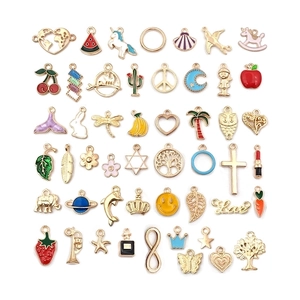 Flat lay of diverse gold alloy enamel pendants for DIY jewelry making and crafts