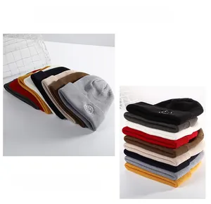 Detail view of multi-color knitted beanies featuring smiley face embroidery and thick texture
