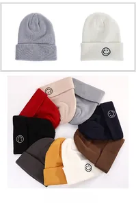 Detailed grid showing knitted beanies in various colors with a smiley face embroidery