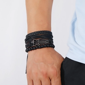 Multilayer black leather guitar bracelet with woven strands and beads on a male wrist
