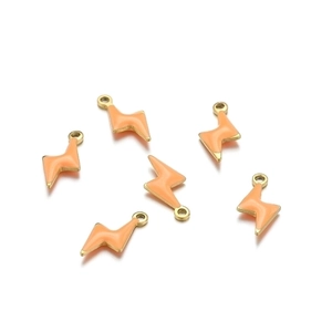 Detail view of six lightning bolt pendants with orange enamel and gold metal edges