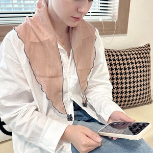 Light pink semi-transparent triangular scarf with grey wavy edges and pleated texture