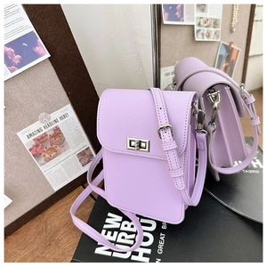 Detail view of purple saffiano leather mini bag with silver clasp and long strap