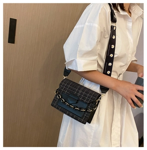 Detail of tweed crossbody bag with matte chain and daisy print wide shoulder strap