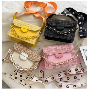 Detail of colorful crossbody bags featuring woven texture and daisy print wide straps