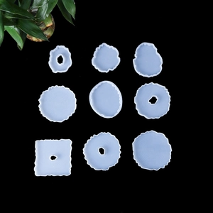 Detailed overhead view of 9 irregular silicone resin molds in wave edge agate slice style