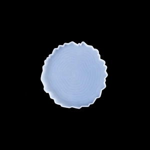 Macro shot of irregular light blue silicone coaster mold with wood grain texture