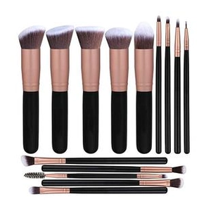 Detail of 13 professional makeup brushes with black handles and rose gold ferrules