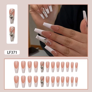 French press-on nails with white tips, 3D butterfly charms and rhinestone detailing