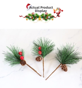 Detailed view of three Christmas pine needles with pine cones and red berries on marble