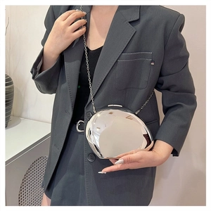 Close-up of trendy silver mirror acrylic box bag with stylish chain strap for women