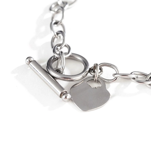Polished silver stainless steel chain bracelet featuring heart charm and OT toggle clasp