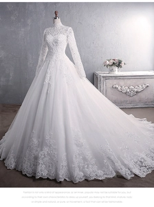 Detail of high neck lace embroidery and long sleeves on a white bridal gown with train