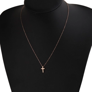 Polished rose gold stainless steel cross pendant necklace on a black mannequin display