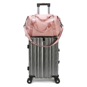 Pink waterproof fitness bag for women with luggage sleeve and adjustable shoulder strap