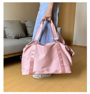 Detailed view of pale pink waterproof gym bag with reinforced handles and sturdy D-rings