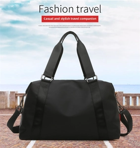 Detailed view of the black waterproof travel bag with reinforced handles and strap