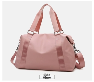 Pink waterproof fitness bag featuring fabric handles and adjustable shoulder strap detail