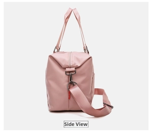 Detailed side view of pink fitness bag with adjustable shoulder strap and water-resistant nylon