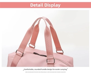 Detail of pink fitness bag showing metal buckles, dual handles and sturdy top zippers