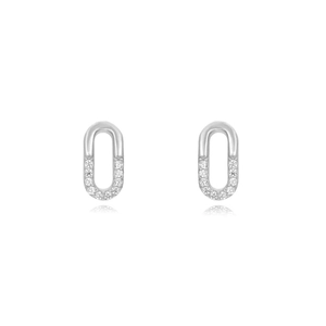Close-up of silver oval link earrings with sparkling crystal accents and polished finish