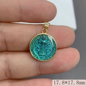 Detailed macro view showing the 17.8mm round green enamel Saint Benedict medal pendant