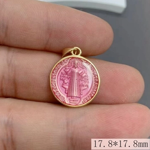 Detailed view of pink enamel Saint Benedict medal pendant showing 17.8mm size scale