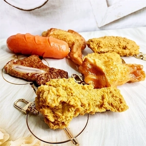 Detailed view of realistic fried chicken and sausage keychains with gold lobster clasps