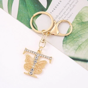 Detail of gold letter T keychain with crystal butterfly and sparkling rhinestones