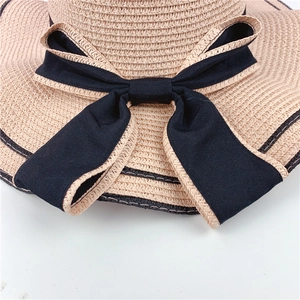 Elegant summer straw sun hat with large black bow for beach vacations