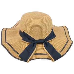 Elegant women's straw sun hat featuring a black bow ribbon for beach vacations