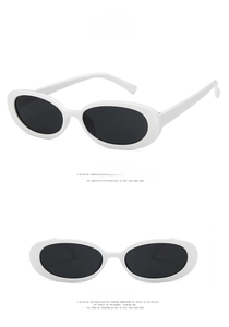 Detail view of oval cow-print sunglasses with solid white frames and grey lenses