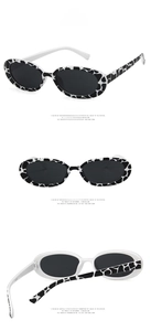 Detailed views of cow print oval sunglasses with dark grey lenses from multiple angles