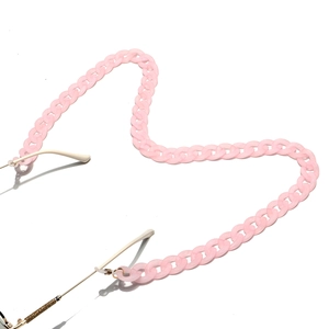 Pink frosted acrylic eyeglass chain in fluid S-curve layout on white background