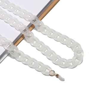 Detailed view of matte white acrylic glasses chain with gold links on minimalist background