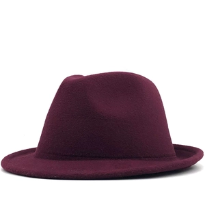 Close-up of the burgundy wool felt fedora showing the smooth fabric texture and classic crown