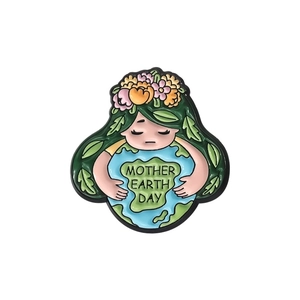 Enamel brooch with Earth Mother embracing the globe for Mother Earth Day awareness