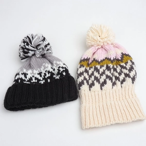 Winter geometric knit beanies with pom-poms in colorful diamond patterns for warmth