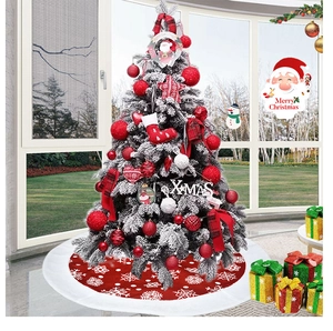 Close-up of red snowflake tree skirt with Christmas ornaments and gift boxes