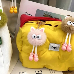 Cute fuzzy coal ball plush keychains in pink and brown with big eyes and small shoes