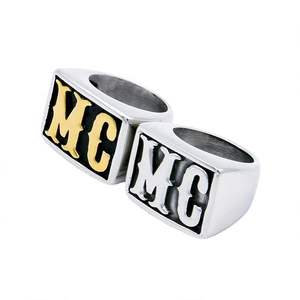 Detailed view of men's wide stainless steel rings featuring engraved MC letters